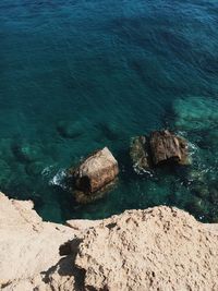 High angle view of rocks by sea