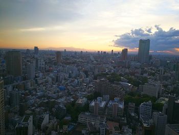 High angle view of buildings in city against sky during sunset