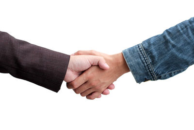 Cropped image of businessmen shaking hands over white background