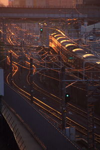 High angle view of train moving on railroad track during sunset