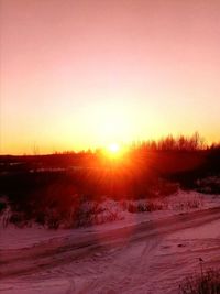 Scenic view of snowy landscape against sky during sunset