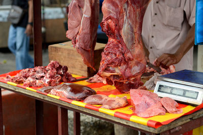 Cropped image of man preparing food on barbecue grill