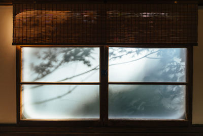 Low angle view of glass window against sky