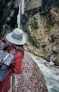 Woman admiring a rocky gorge in winter.