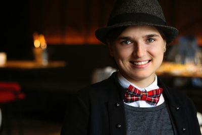 Woman wearing in british or english style clothes smiling indoor. masculine woman. young smiling 