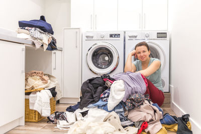 Portrait of smiling woman at laundromat