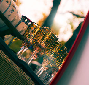 Close-up of glass of bottles against sky