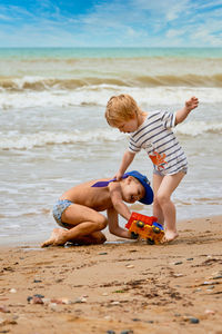 Children playing with toy on beach