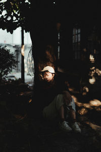 Portrait of smiling woman sitting at night