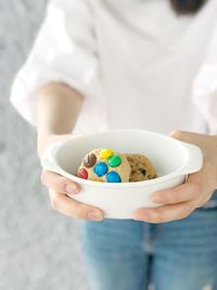 High angle view of hand holding ice cream in bowl