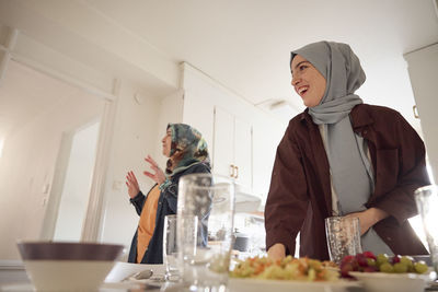 Women in headscarves preparing eid al-fitr at home