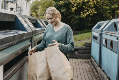 Woman recycling rubbish