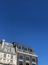 Low angle view of building against blue sky