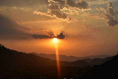 Scenic view of silhouette mountains against sky during sunset