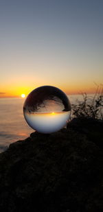 Scenic view of sea shore against sky during sunset