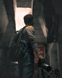 Side view of man holding camera