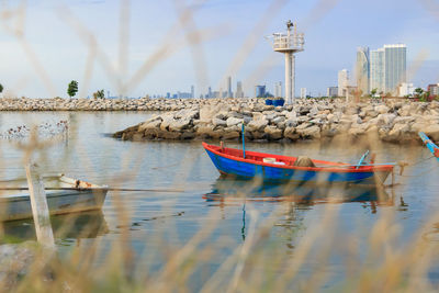 Boats moored on sea against sky