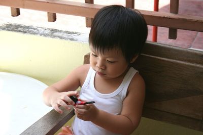 Close-up of boy playing with toy at home