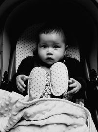 Portrait of cute baby girl in baby stroller