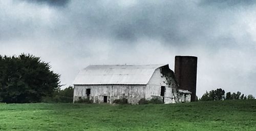 Built structure on field against sky