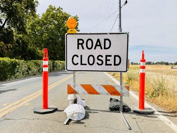 Information sign on road by street