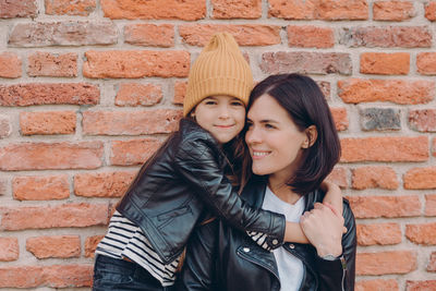 Portrait of girl embracing mother