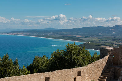 High angle view of sea and mountains against sky