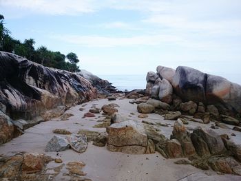 Rocks on beach against sky