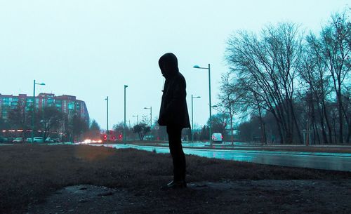 Man walking on street against clear sky