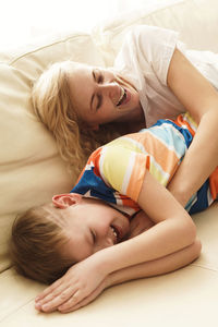 Young woman lying on bed at home