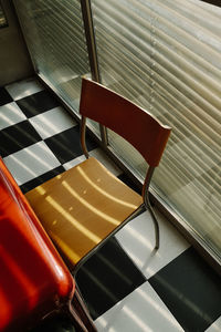 High angle view of empty chair on table