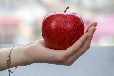 Close-up of hand holding strawberry