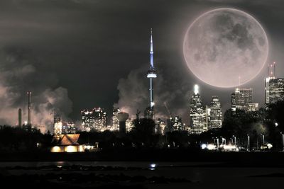 Illuminated cityscape against sky at night