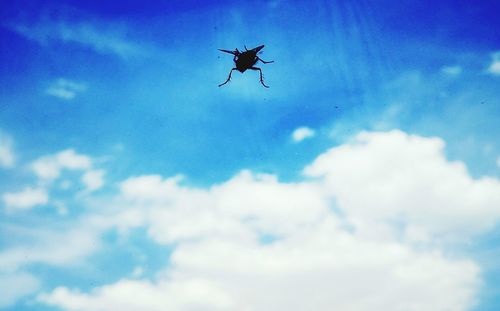 Low angle view of helicopter flying against sky