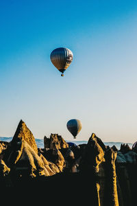 Low angle view of hot air balloons flying in sky