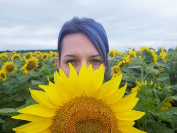 Portrait of woman with yellow flower