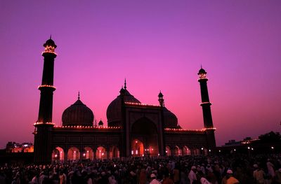 Group of people in front of building during sunset