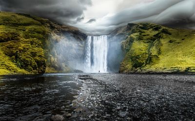 Scenic view of waterfall against sky