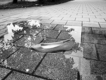 High angle view of puddle on sidewalk