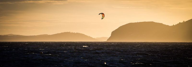 Silhouette of man jumping in sea