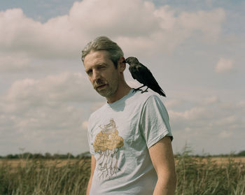 Man standing on field against sky