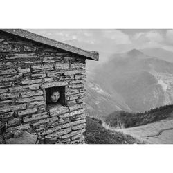 Old house on mountain against sky