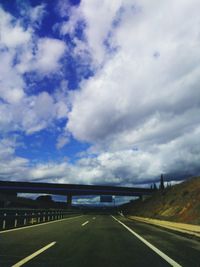 View of highway against cloudy sky