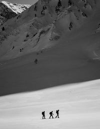 High angle view of people walking on snow covered landscape