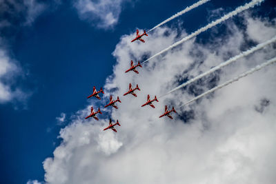 Low angle view of airshow against sky