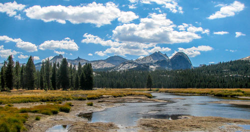 Scenic view of landscape and mountains against cloudy sky