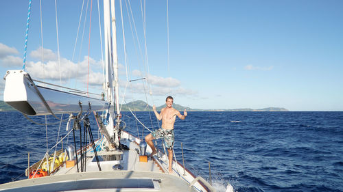 Panoramic view of man sailing on sea against sky