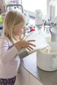 Girl holding ice cream at home