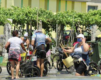 Rear view of people riding bicycle