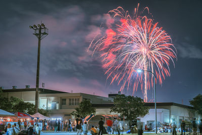 Low angle view of people on street at night